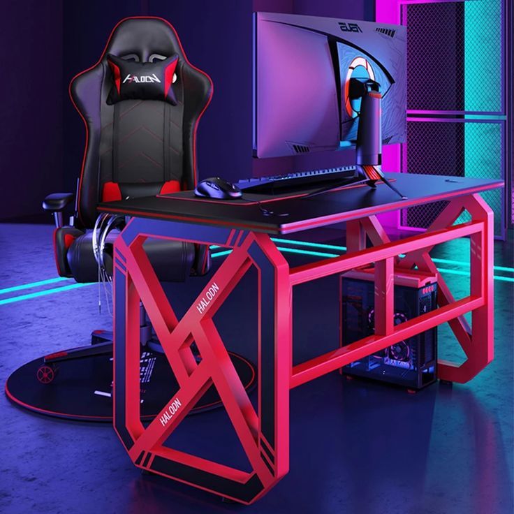 a computer desk with a gaming chair next to it and a monitor on the table