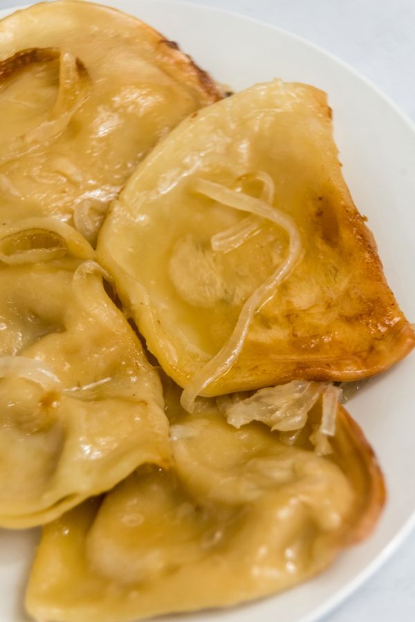 some dumplings are sitting on a white plate