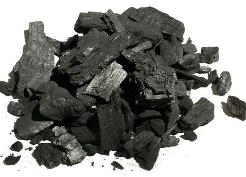 a pile of black coal sitting on top of a white table