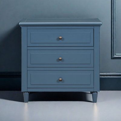 a blue chest of drawers in a room