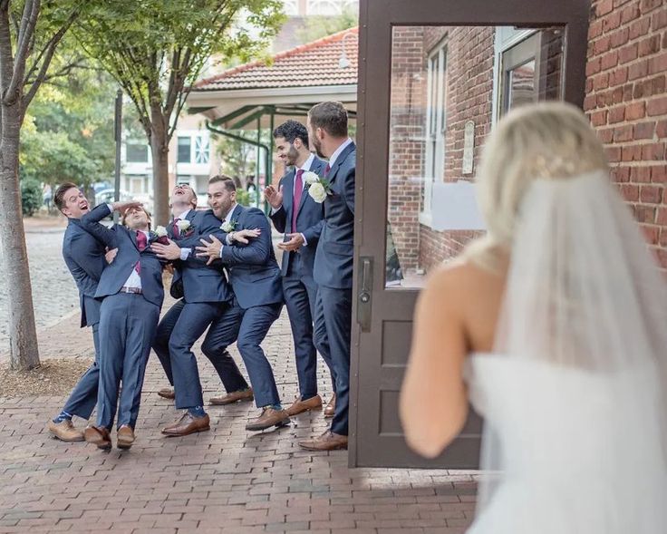 a group of people standing around each other in front of a door