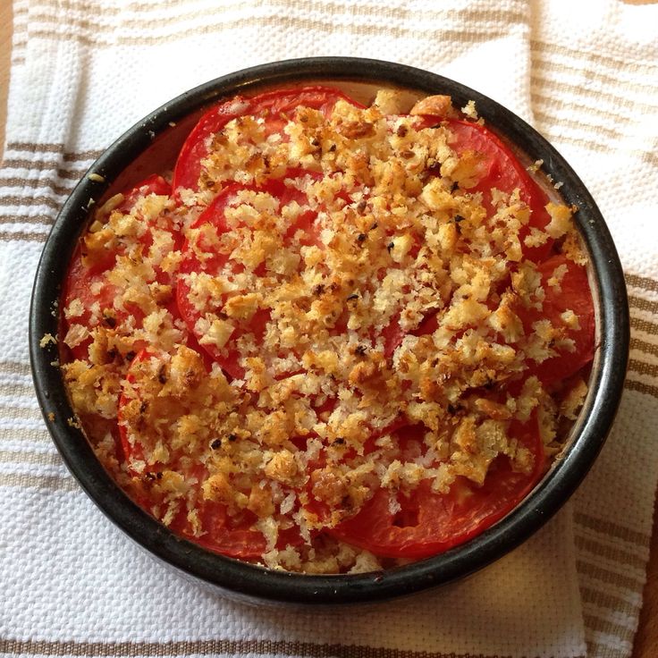 a bowl filled with food sitting on top of a white towel