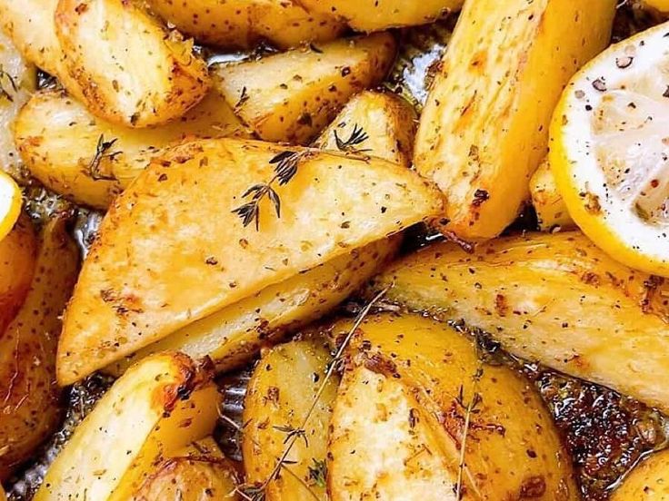 potatoes with lemon slices and herbs on them