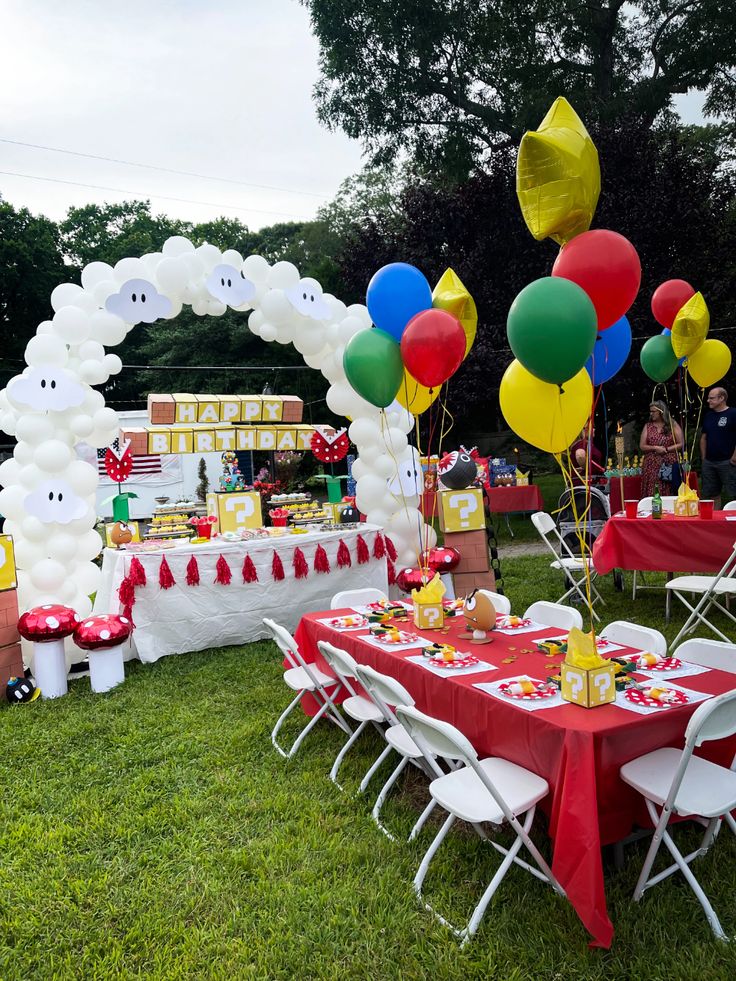 an outdoor party with balloons and decorations