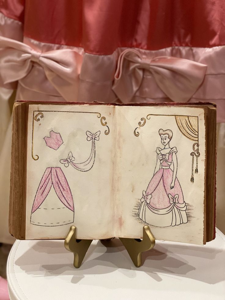 an open book with princess drawings on it