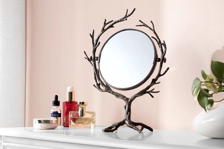 a mirror sitting on top of a white mantle