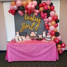 a pink table topped with lots of balloons