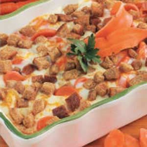 a casserole dish filled with carrots and meat