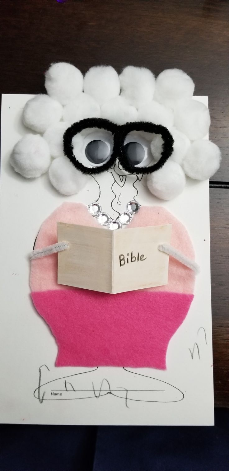 a paper cut out of a sheep with sunglasses on it's head and a note attached to its ear