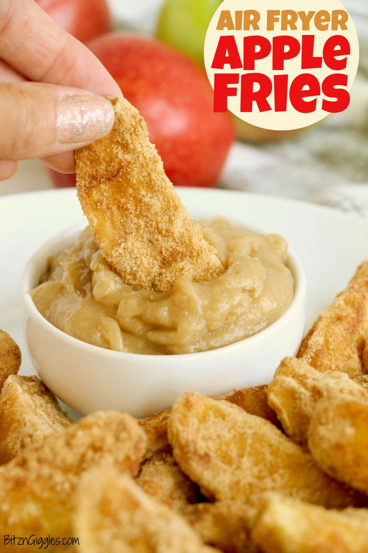 a person dipping an apple into a bowl of fried apples with the words air fryer apple fries above it