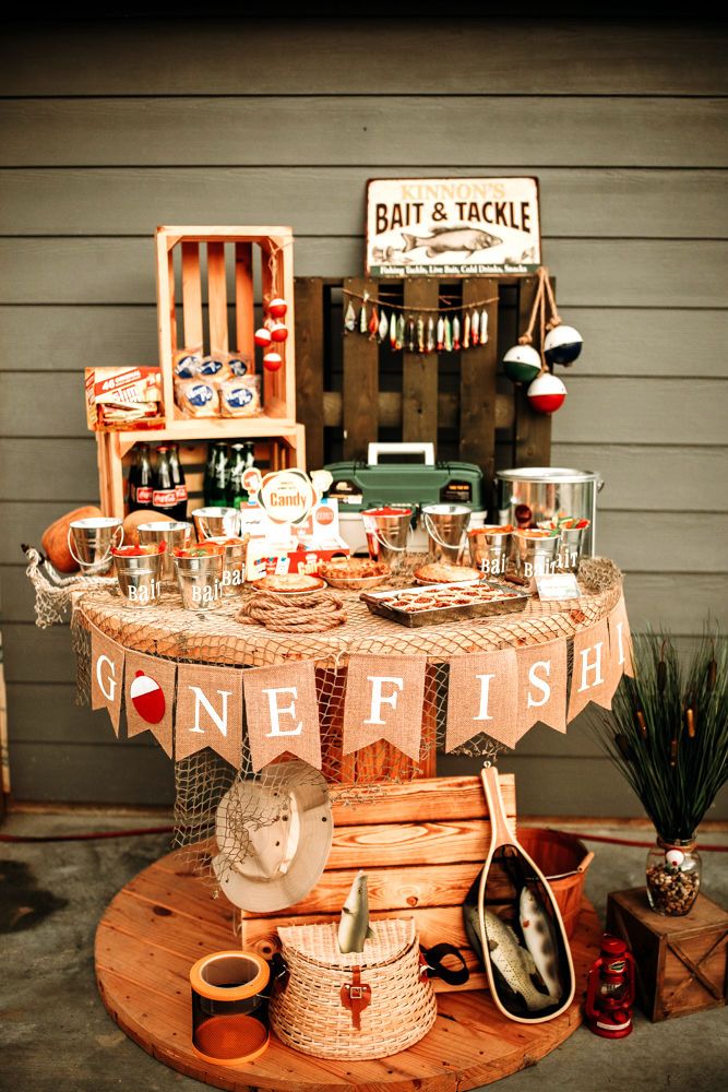 a wooden table topped with lots of dishes next to a sign that says one fish