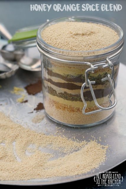 a jar filled with cake mix sitting on top of a table next to spoons