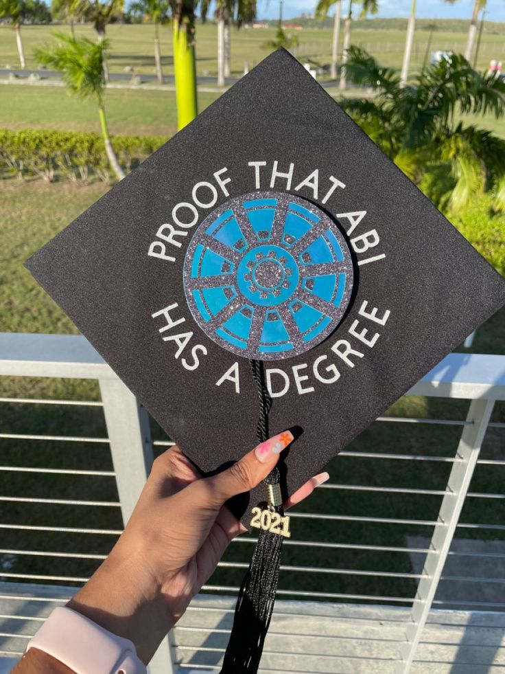 someone is holding up a graduation cap that says proof that ball has a degree on it