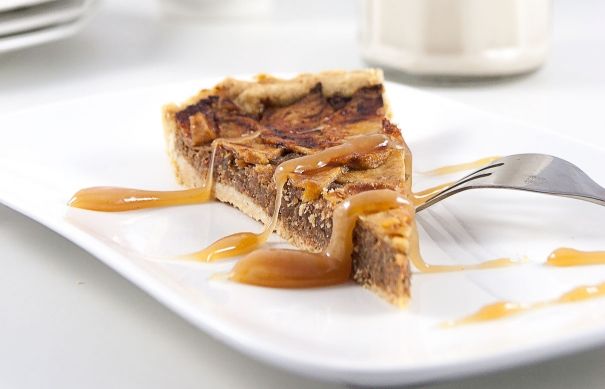 a piece of pie on a plate with caramel sauce