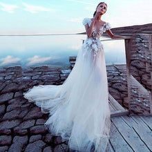 a woman in a white dress standing on a dock