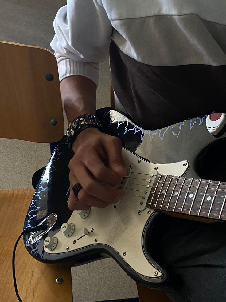 a man is playing an electric guitar