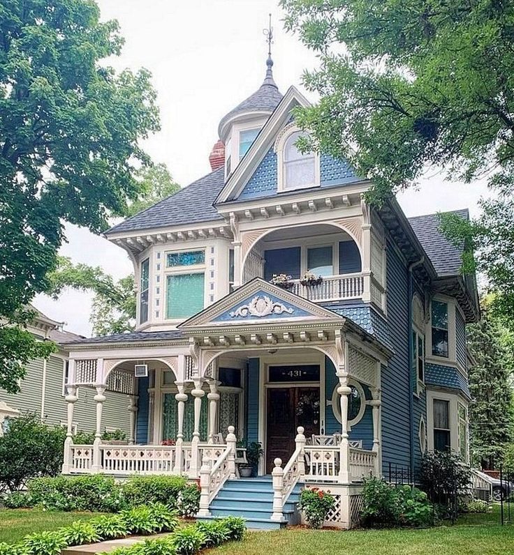 a blue and white victorian style house in the suburbs