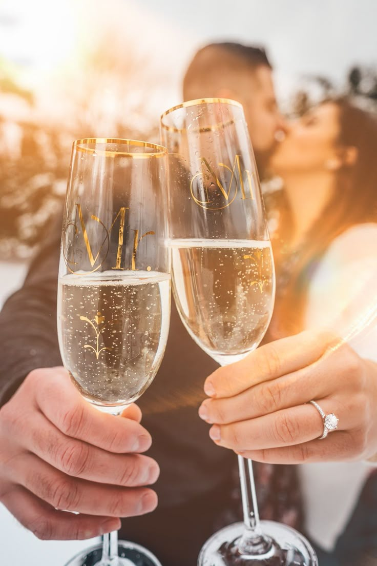 two people holding champagne glasses in their hands