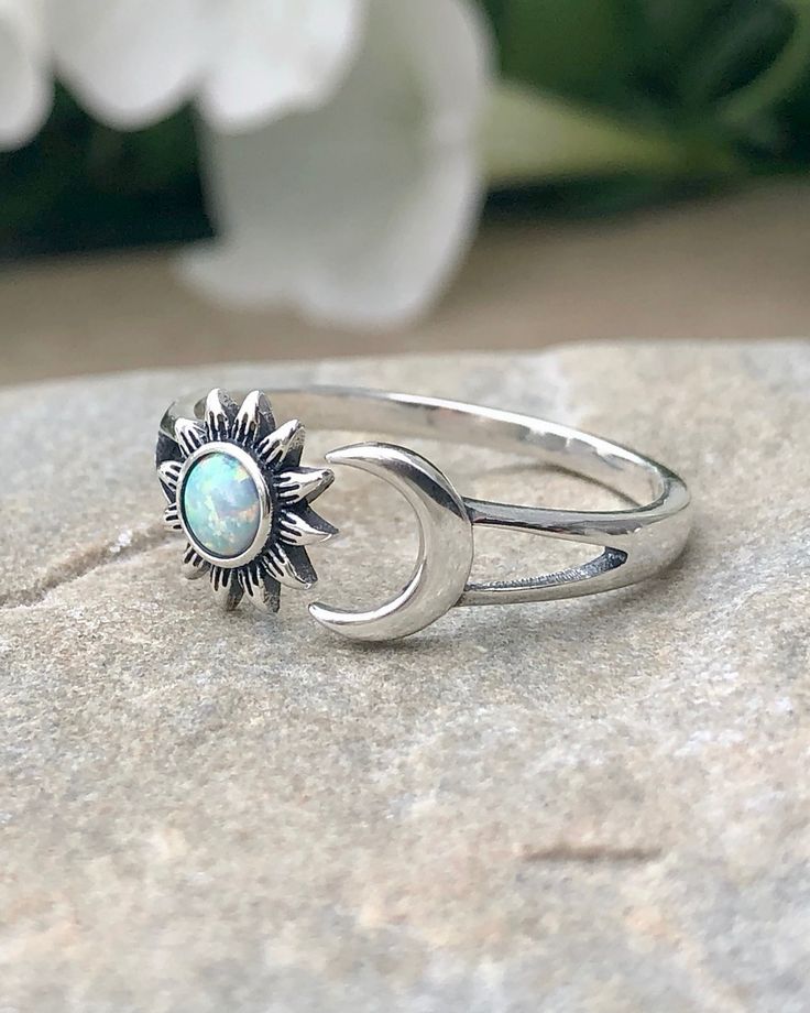 Sterling Silver Sun and Moon White Lab Opal Ring | The Life Divine This beautiful ring represents balance, the blending of the masculine and feminine energies within each of us. The Moon is a feminine symbol and represents the light that shines within each of us. She reminds us that all things on earth have a natural cycle. Known for its radiance, The Sun is a masculine symbol which represents energy and vitality. Cherished for its brilliance, Opal is known as a stone of creativity and vitality. Adjustable Moon Shaped Promise Ring, Adjustable Sun And Moon Design Promise Rings, Nickel-free Celestial Moon Ring, Adjustable Crescent Moon Phase Ring, Symbolic Adjustable Crescent Jewelry, Adjustable Open Ring With Sun And Moon Design, Adjustable White Jewelry With Sun And Moon Design, Celestial Adjustable Open Ring Jewelry, Adjustable Crescent Symbolic Jewelry