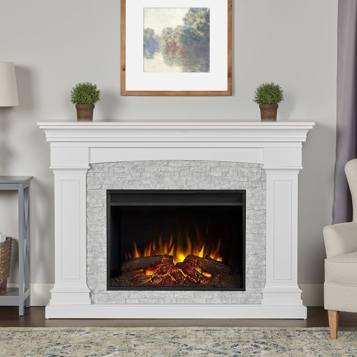 The Deland Grand electric fireplace is certain to become the focal point of any room. This fireplace features the Real Flame Grand Series firebox, which is 30% larger than our standard firebox and has incredible realism and clarity. The Deland is available in white with gray resin surround and gray with black wood surround. Real Flame 63-in W White Free Standing Fan-forced Flat Wall Electric Fireplace with Remote Control Included | 8290E-W White Fireplace Mantel On Light Stone, Electric Fireplace Mantle The Home Depot, White Electric Fireplace, Infrared Fireplace, Electric Fireplace Insert, Wall Mount Electric Fireplace, Real Flame, Fireplace Remodel, Indoor Fireplace