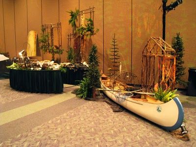 there is a boat that is on the floor next to some trees and other decorations