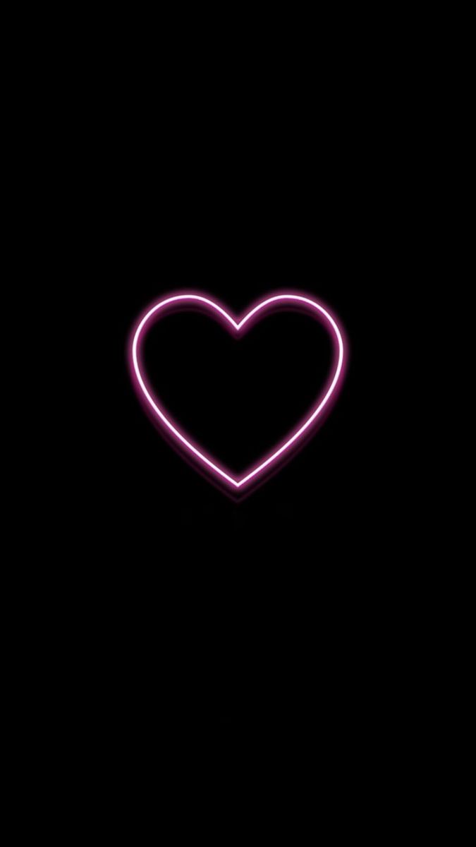 a heart shaped neon sign in the dark with no light on it's side