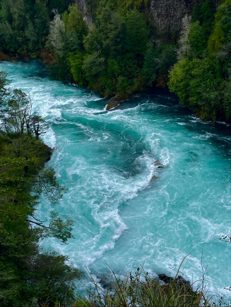 the water is very blue and green in this photo, it looks like something you can see from above