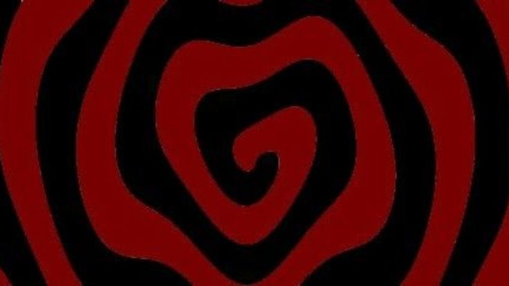 an abstract red and black background with swirly spirals in the center, forming a heart shape