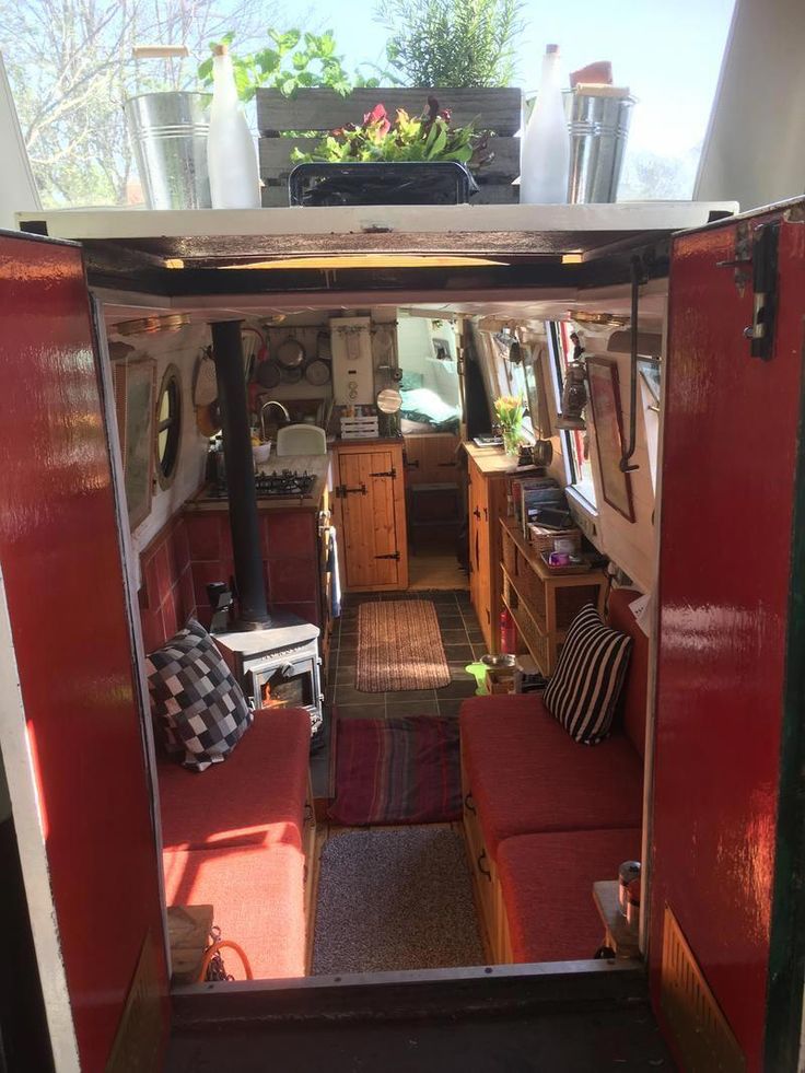 the inside of an rv with red couches and other items in it's storage compartment