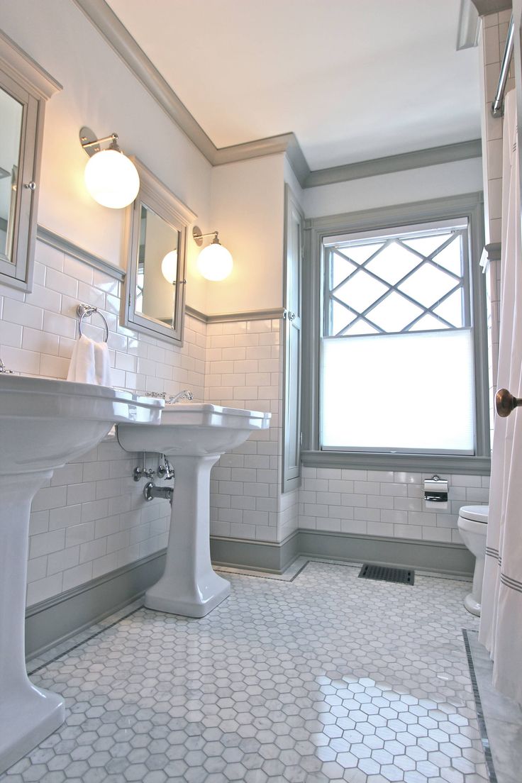 a bathroom with two sinks and a toilet