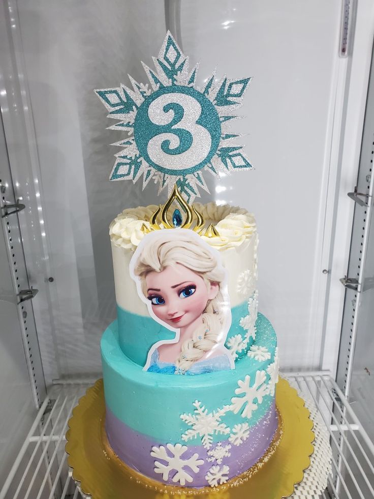 a frozen princess birthday cake with the number three on top