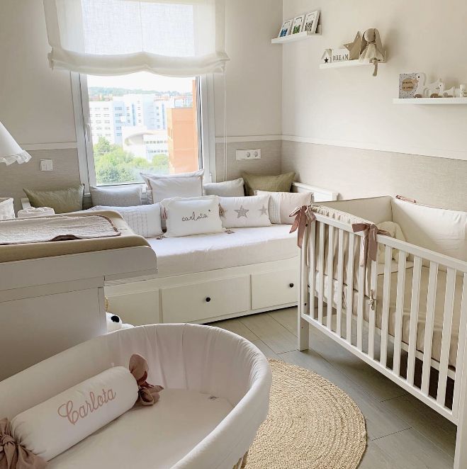 a baby's room is decorated in white and pink