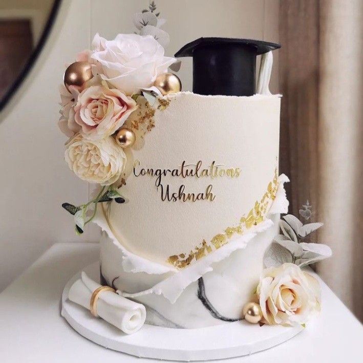 there is a wedding cake decorated with flowers on the top and congratulations written on the side