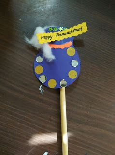 a blue and yellow stick with writing on it sitting on top of a wooden table