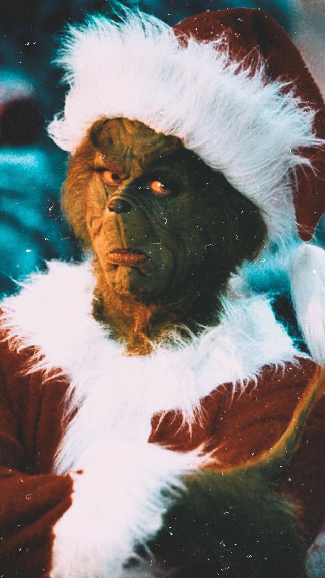 a man dressed up as the grinch in a christmas costume with white fur on his head