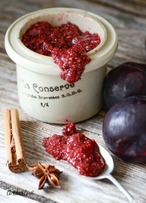 plums and cinnamon are on the table next to a jar of jam