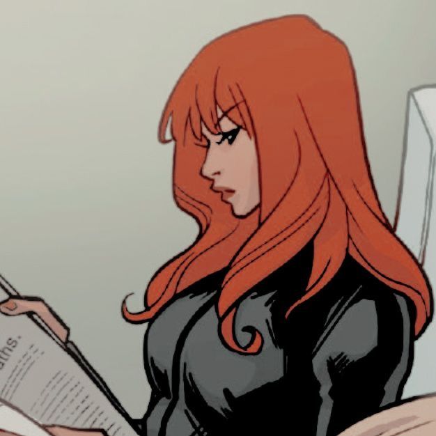 a woman with long red hair reading a book