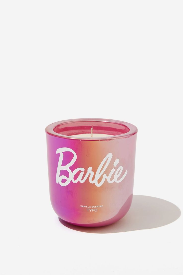 a pink candle with the word barbie written in white letters on it, against a white background