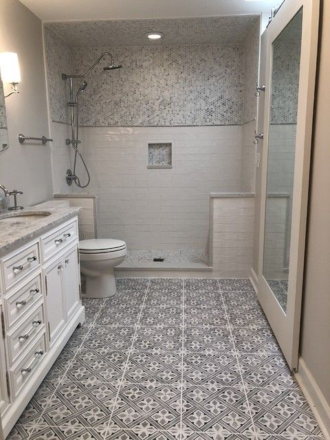 a bathroom with a toilet, sink and shower