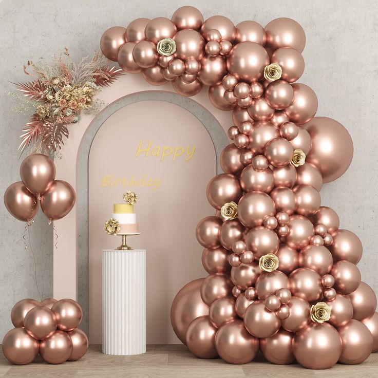 an arch made out of balloons and gold decorations