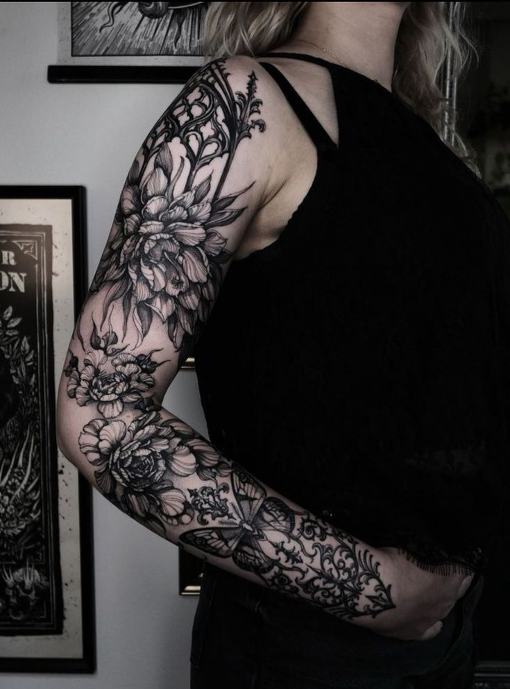 a woman with tattoos on her arm and shoulder