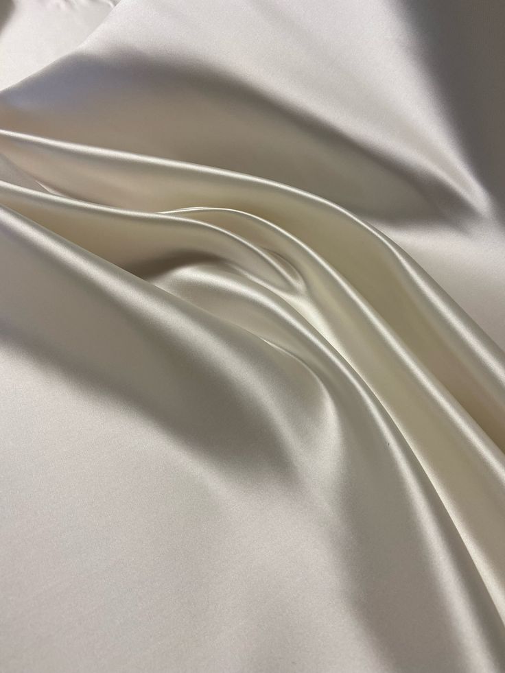 This beautiful white Bridal Satin fabric is perfect for all of your formal garment projects. Imagine the most beautiful wedding dress in this expensive nonstretch Satin.  This fabric is recycled and it is the excess of a previous project. The total amount of fabric is 3 yards available.  $4.00 per yard. You can get this fabric cut per yard.  Please note:  If you would like to purchase all 3 yards of fabric, you can send me an email and I'll send you an invoice to purchase the fabric. That price Elegant Satin Finish Fabric For Wedding, Elegant Wedding Fabric With Satin Finish, Elegant Satin Fabric For Wedding, Elegant Wedding Satin Fabric, Elegant Beige Fabric For Wedding, Wedding Silk Fabric With Satin Finish, Elegant Beige Wedding Fabric, Cream Silk Fabric For Wedding, Elegant Cream Fabric For Wedding