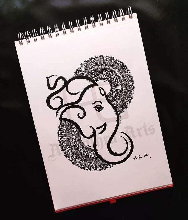 a spiral notebook with an elephant drawn on it