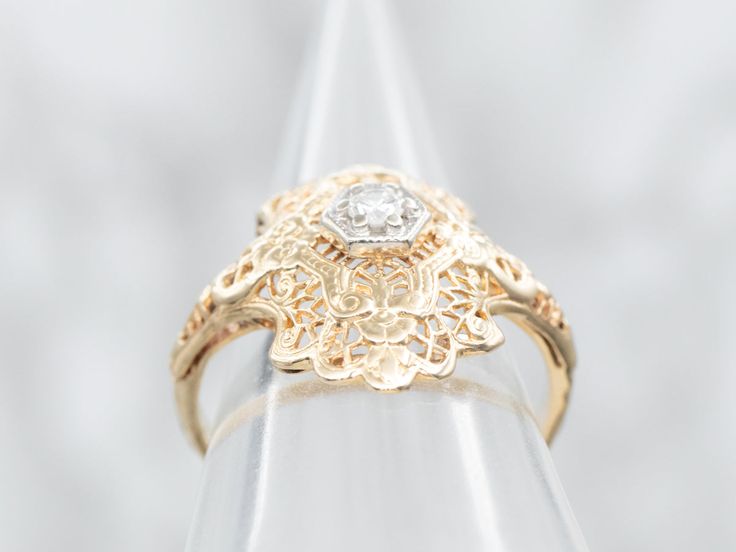 Crafted out of resilient 14-karat yellow gold, this art deco dinner ring is both affordable and eye-catching. A sparkling diamond is set into the center of the ring, which rises slightly to create a sleek and subtle height off the hand. Metal: 14K Yellow and White GoldGem: Diamond .10 Carats, G in Color, SI2 in ClarityGem Measurements: 2.5 mm, RoundRing Size: 6Marks: "FX 14K" Stamped on the inside band Art Deco Yellow Gold Filigree Ring Gift, Vintage Yellow Gold Diamond Signet Ring, Art Deco Yellow Gold Diamond-cut Ring, Antique Yellow Gold Diamond Cut Signet Ring, Vintage 14k Gold Diamond-cut Signet Ring, Pocket Watch Chain, Watch Chain, Filigree Ring, Sparkle Diamonds