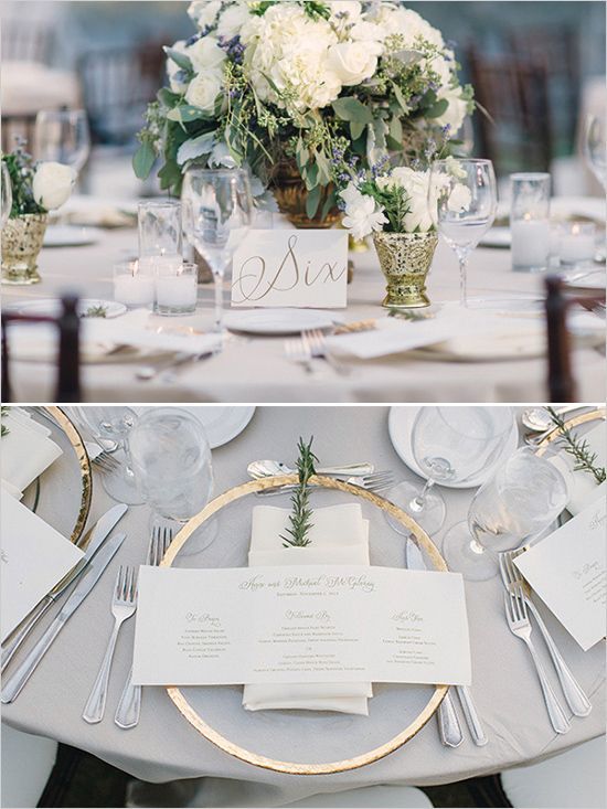 the table is set with white flowers and silverware