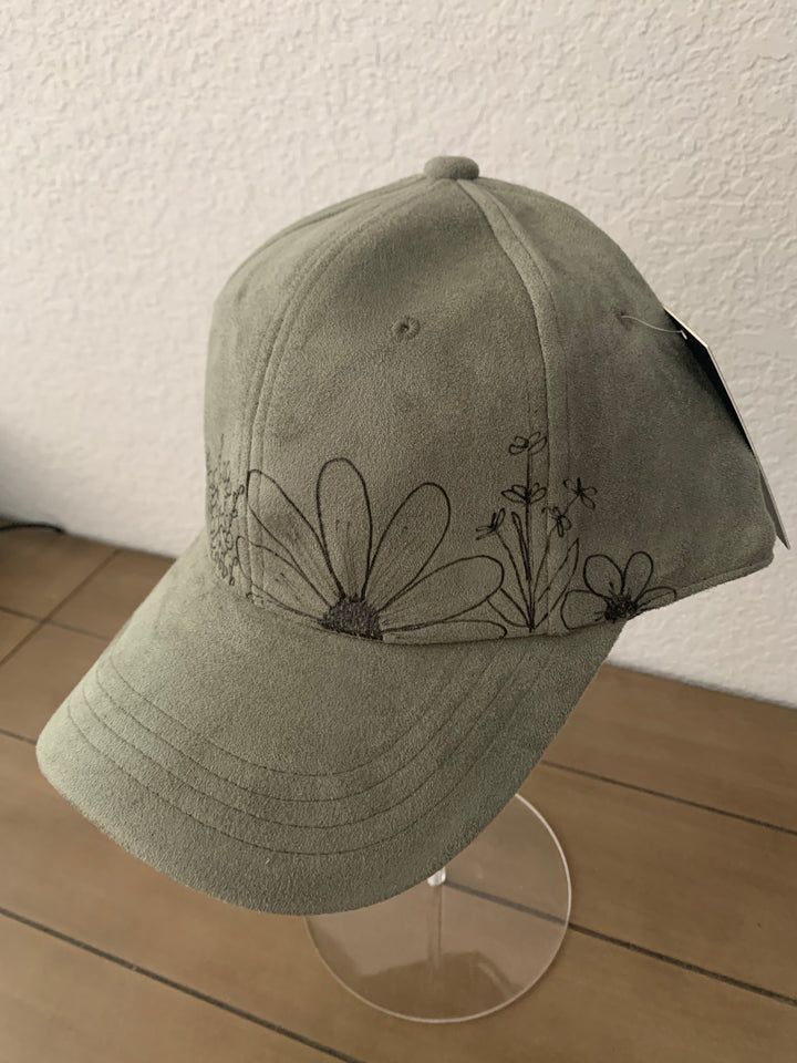 a baseball cap with embroidered flowers on it