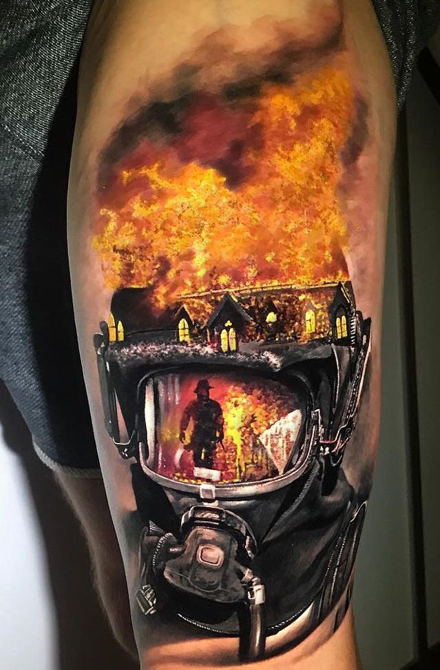 a man's arm with a fire scene on it