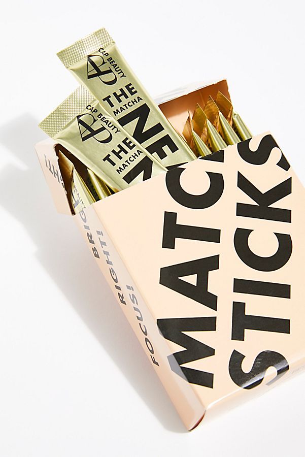 an open matchbox with matches on the front and one in the back that has gold foil sticking out of it