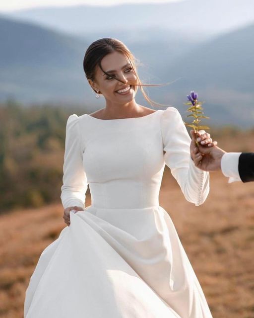 a woman in a white dress holding a flower