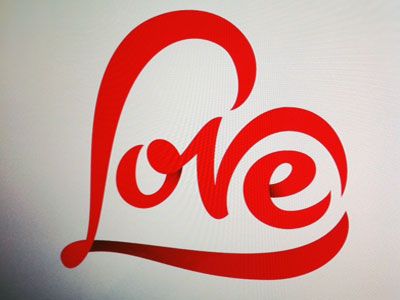 the word love is written in red on a computer screen with a heart shaped design